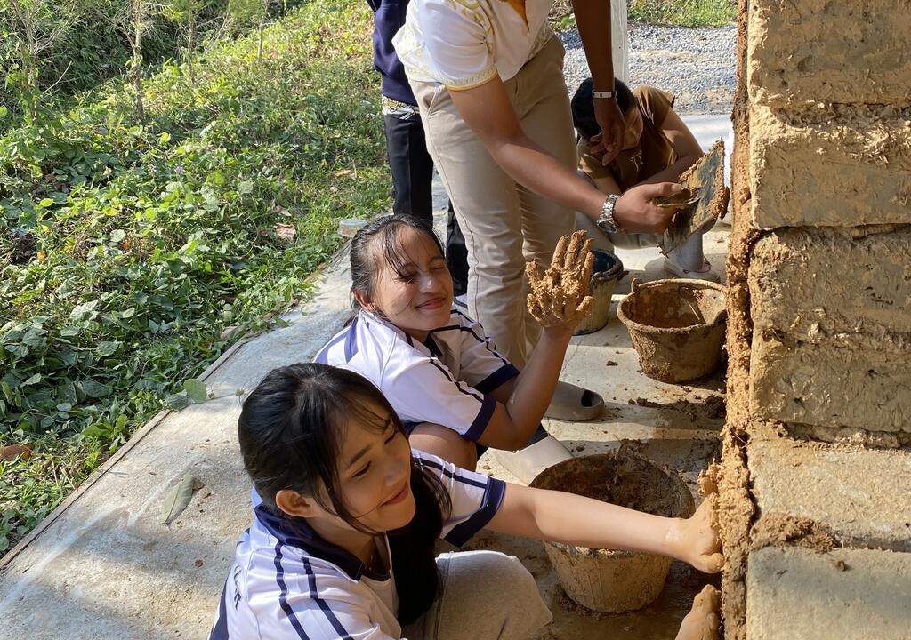 Real volunteers building mud house at Day One Stay Farm Suan Tae Raek Trang Thailand